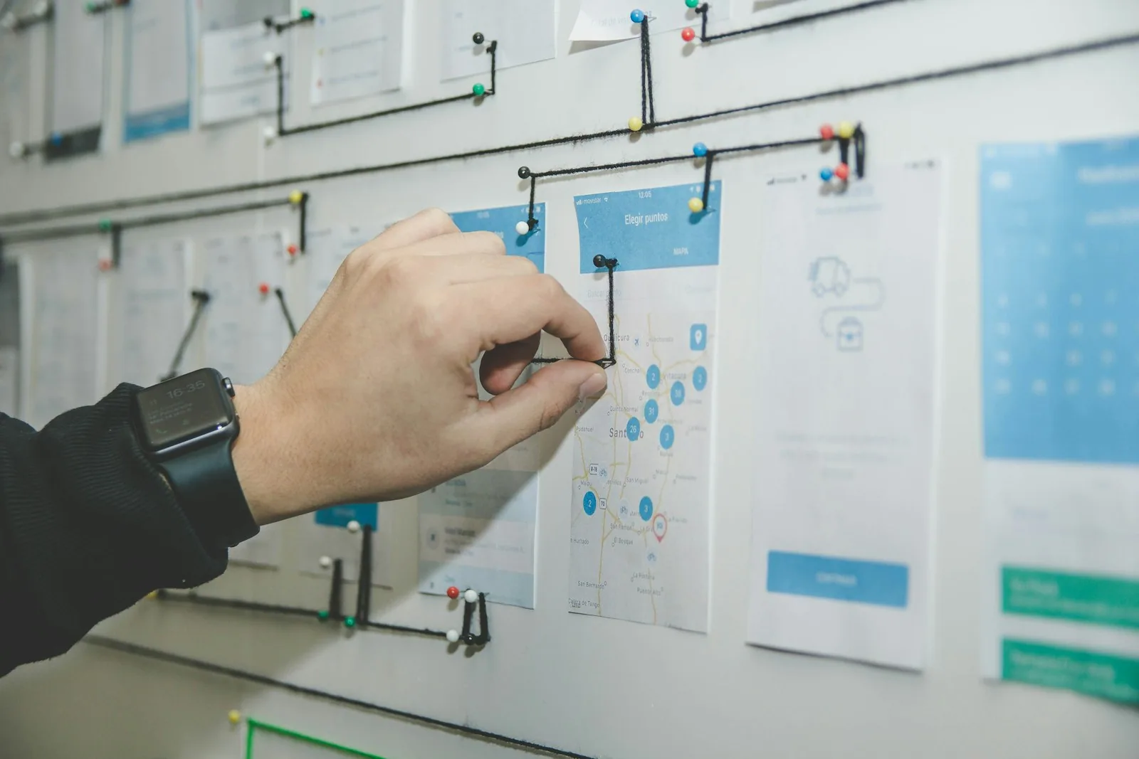 Board con materiali collegati da fili, simile a una mappa visiva di idee e fonti